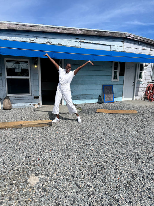 Lois Samuels with hands lifted to the sky and big smile on her face. Sanding in front of WSMR studio