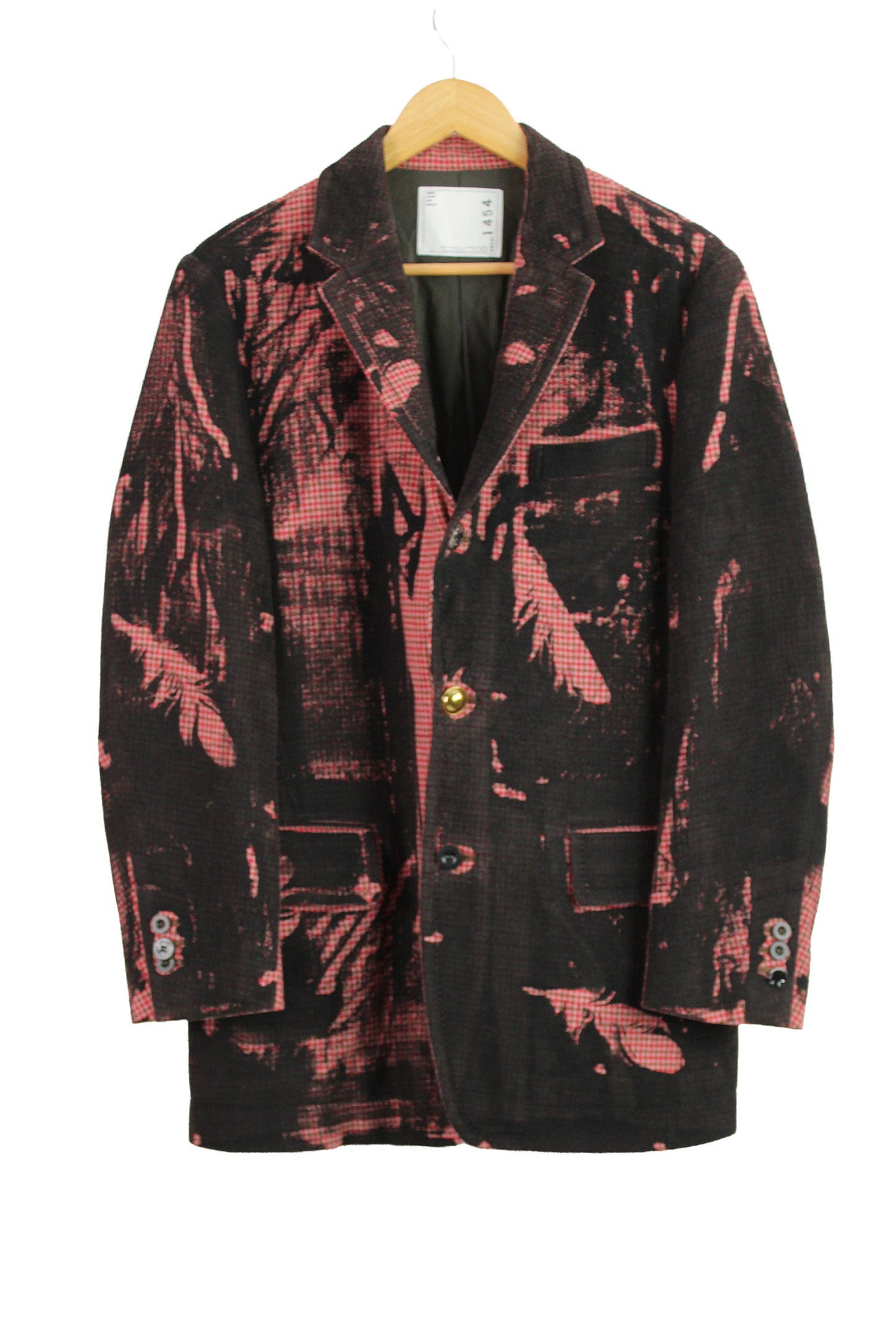 Black and red patterned coat on a hanger against a white background