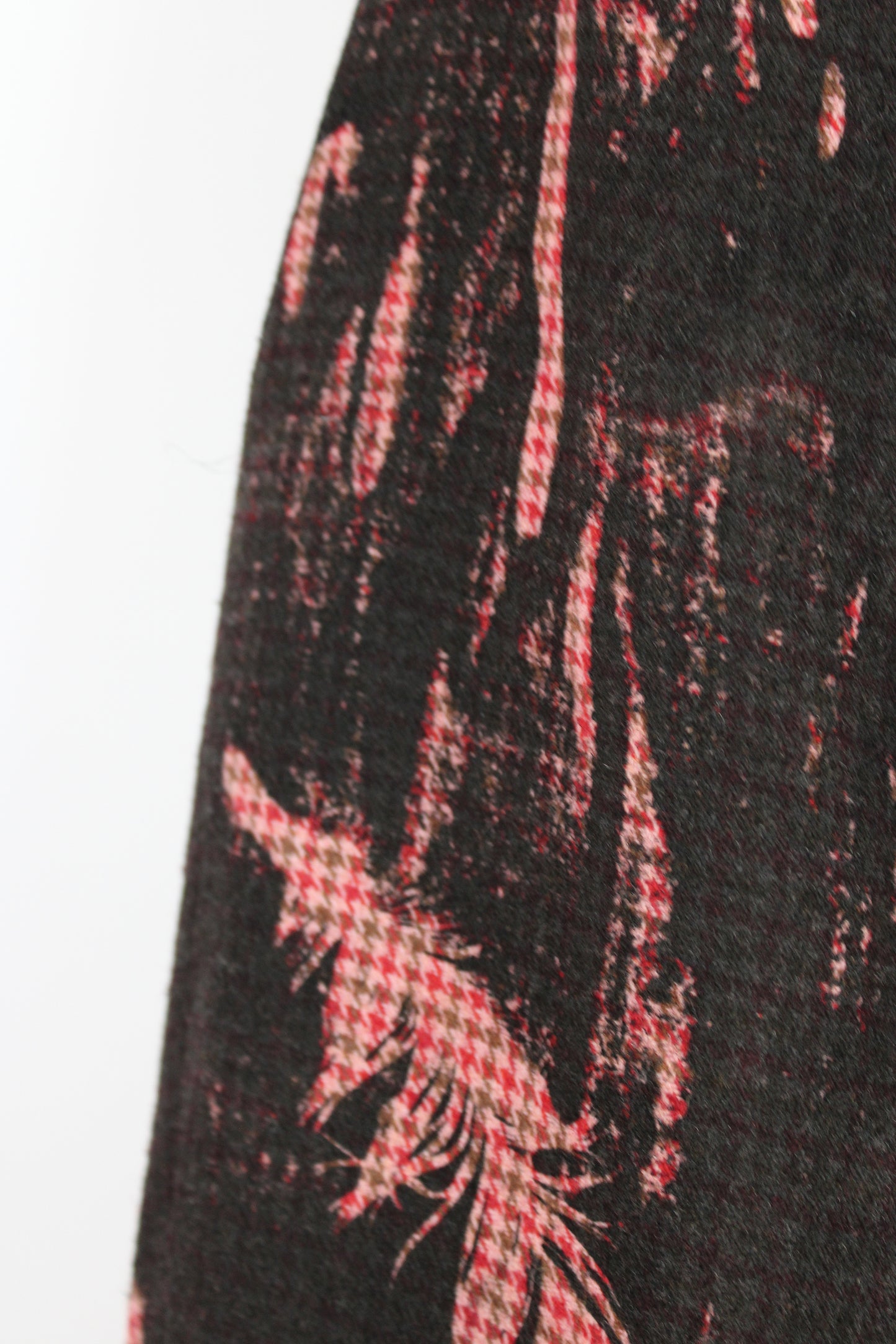 Close-up of a patterned fabric with red and white design on a black background